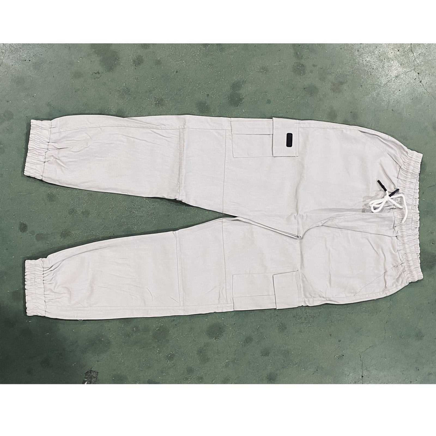 Men's beige waterproof hiking pants with drawstring waist and pockets, breathable and quick-dry for camping summer hiking