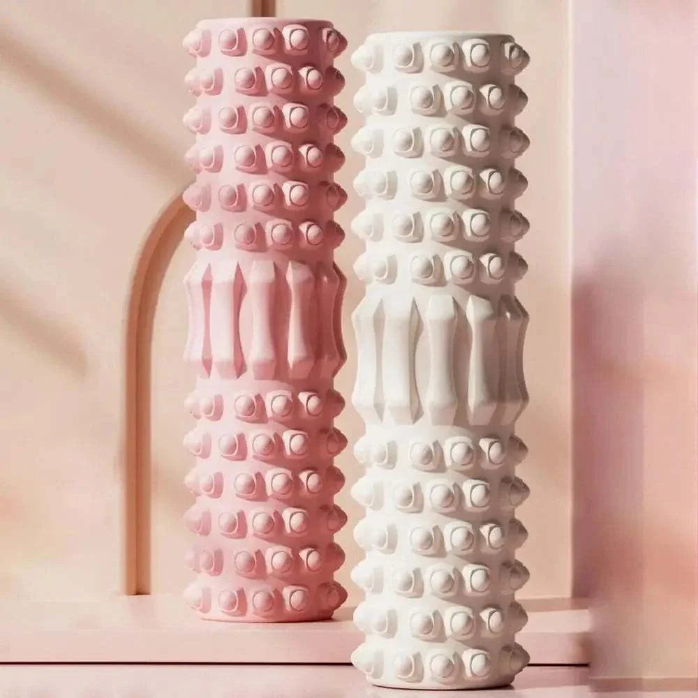 Pink and white high density foam muscle massage rollers with textured surface for body recovery and fitness