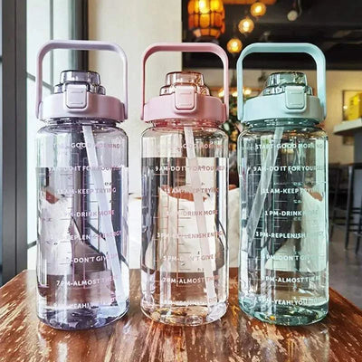 Set of three 2L plastic kettle-style sports water bottles with straws and motivational time markers, available in pastel purple, pink, and green colors.