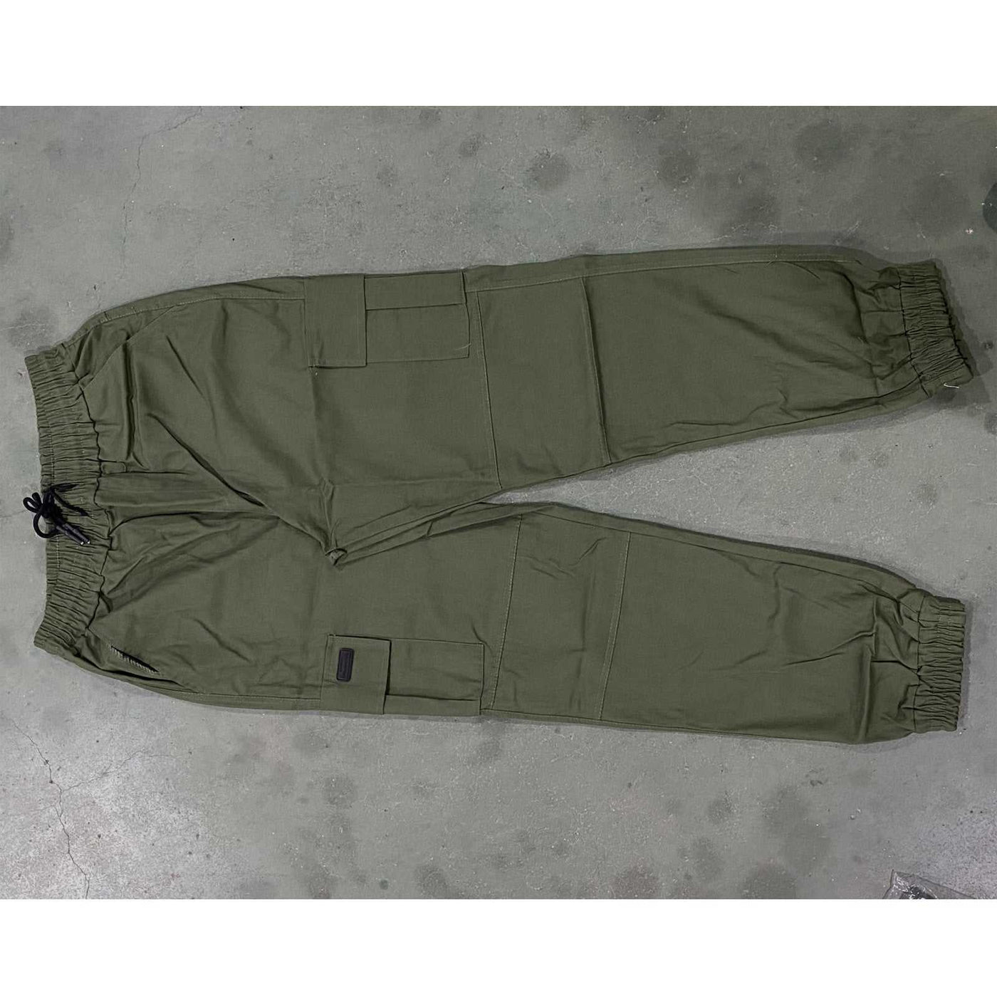 Men’s olive green outdoor waterproof hiking pants with pockets, breathable quick-dry fabric, and drawstring waist for camping summer hiking.